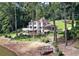 Beautiful two-story home on a lake with a large deck, screened in porch, and lush landscaping at 1530 Niskey Lake Sw Trl, Atlanta, GA 30331