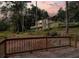Charming two-story home with a deck, screened in porch, lake view, and lush landscaping at 1530 Niskey Lake Sw Trl, Atlanta, GA 30331