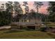 Charming two-story home with stone foundation and lush landscaping at sunset at 1530 Niskey Lake Sw Trl, Atlanta, GA 30331