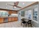 Well-lit kitchen with wooden cabinets, stainless steel appliances, a ceiling fan, and tiled floors, ideal for modern living at 1530 Niskey Lake Sw Trl, Atlanta, GA 30331