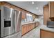 Well-lit kitchen featuring stainless steel appliances, wooden cabinets, and a tiled floor, ideal for cooking and entertaining at 1530 Niskey Lake Sw Trl, Atlanta, GA 30331