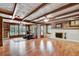 Large living room showcasing exposed beam ceilings and a whitewashed brick fireplace at 1530 Niskey Lake Sw Trl, Atlanta, GA 30331