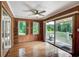Bright sunroom with hardwood floors, wood paneling, and panoramic views of the surrounding landscape at 1530 Niskey Lake Sw Trl, Atlanta, GA 30331