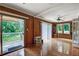 Cozy sunroom features hardwood floors, natural light, and sliding door access to the deck at 1530 Niskey Lake Sw Trl, Atlanta, GA 30331