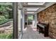 Sunroom featuring stone accent wall, tile floors, skylights, and large glass windows at 1530 Niskey Lake Sw Trl, Atlanta, GA 30331
