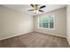 Cozy bedroom with neutral paint, carpet, a ceiling fan, and a large window at 2004 Township Dr, Woodstock, GA 30189