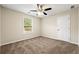 Comfortable bedroom featuring carpet floors, ceiling fan, and natural light from a window at 2004 Township Dr, Woodstock, GA 30189