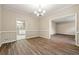Neutral dining room featuring hardwood floors, chair rail detail, and ample natural light at 2004 Township Dr, Woodstock, GA 30189