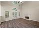 Light-filled living room boasts a fireplace, hardwood floors, and soaring ceilings at 2004 Township Dr, Woodstock, GA 30189