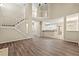 Open living room with hardwood floors, staircase, and views of the kitchen and upstairs landing at 2004 Township Dr, Woodstock, GA 30189
