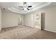 Spacious main bedroom features tray ceilings, ceiling fan, and ensuite bathroom at 2004 Township Dr, Woodstock, GA 30189