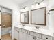 Bright bathroom featuring double vanity and framed mirrors at 3541 Ashcroft Se Dr, Smyrna, GA 30080