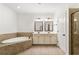 Bathroom featuring double vanity, soaking tub, and glass-door shower at 3541 Ashcroft Se Dr, Smyrna, GA 30080