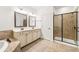 Bathroom featuring double vanity and glass-door shower with neutral color scheme at 3541 Ashcroft Se Dr, Smyrna, GA 30080