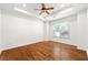 Spacious bedroom with hardwood floors, natural light, a ceiling fan, and tray ceiling at 3541 Ashcroft Se Dr, Smyrna, GA 30080