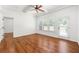 Bright bedroom featuring hardwood floors, ample windows, a ceiling fan, and tray ceiling at 3541 Ashcroft Se Dr, Smyrna, GA 30080