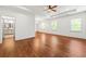 Spacious main bedroom with ceiling fan and hardwood floors, and a view to an en suite bathroom at 3541 Ashcroft Se Dr, Smyrna, GA 30080