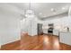 Elegant dining room with hardwood floors, a chandelier, and an open view into the kitchen at 3541 Ashcroft Se Dr, Smyrna, GA 30080
