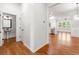Open-concept entryway with hardwood floors and views into the kitchen, dining, and powder room at 3541 Ashcroft Se Dr, Smyrna, GA 30080