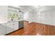 Bright kitchen featuring stainless steel appliances, white cabinets, hardwood floors, and granite countertops at 3541 Ashcroft Se Dr, Smyrna, GA 30080
