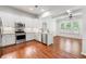 Modern kitchen featuring stainless steel appliances, white cabinets, and hardwood floors with backyard view at 3541 Ashcroft Se Dr, Smyrna, GA 30080