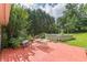Backyard showcasing a wood deck with table, grill, above-ground pool and lush greenery at 4411 Westerling Ct, Powder Springs, GA 30127