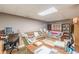 Bright basement with sofas, skylight, television, and staircase to the upper level at 4411 Westerling Ct, Powder Springs, GA 30127