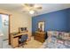 Comfortable bedroom including a desk, dresser, ceiling fan, and bed with decorative quilt at 4411 Westerling Ct, Powder Springs, GA 30127