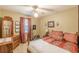 Bedroom featuring a ceiling fan, neutral walls, and a decorative bed with patterned linens at 4411 Westerling Ct, Powder Springs, GA 30127