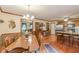 Open floor plan with dining room, breakfast bar, hardwood floors, and view into the living room at 4411 Westerling Ct, Powder Springs, GA 30127
