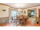 Traditional dining room with wood floors, chandelier, and view into the living room at 4411 Westerling Ct, Powder Springs, GA 30127