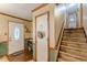 Inviting entryway with a decorative front door, wood accents, and staircase leading upstairs at 4411 Westerling Ct, Powder Springs, GA 30127