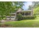 Inviting two-story home with stone accents, a cozy front porch, and a neatly manicured hedge at 4411 Westerling Ct, Powder Springs, GA 30127