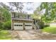 Charming two-story home with a stone facade, a two-car garage, and a well-manicured lawn at 4411 Westerling Ct, Powder Springs, GA 30127