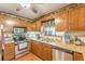 Updated kitchen with stainless steel appliances and natural wood cabinets at 4411 Westerling Ct, Powder Springs, GA 30127