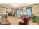 Cozy living room featuring a stone fireplace, plush seating, and bright windows at 4411 Westerling Ct, Powder Springs, GA 30127