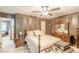 Bedroom featuring a ceiling fan, striped walls, dark furniture and a large decorative bed at 4411 Westerling Ct, Powder Springs, GA 30127