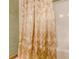 Close up of a shower with a decorative gold floral shower curtain at 4411 Westerling Ct, Powder Springs, GA 30127