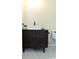 Bathroom vanity with a modern vessel sink, dark wood finish, and hexagonal floor tile at 5974 Sw Four Winds Sw Dr, Lilburn, GA 30047