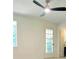 Large bright room featuring ceiling fan, window, and glass paned door at 5974 Sw Four Winds Sw Dr, Lilburn, GA 30047