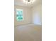 Spacious bedroom with neutral carpet and modern lighting at 5974 Sw Four Winds Sw Dr, Lilburn, GA 30047