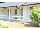 Inviting front porch with white railings and a stylish entry door at 5974 Sw Four Winds Sw Dr, Lilburn, GA 30047