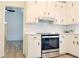 Bright kitchen features white cabinets, subway tile backsplash, and stainless steel oven at 5974 Sw Four Winds Sw Dr, Lilburn, GA 30047