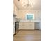 Well-lit kitchen featuring white cabinets, stainless steel appliances, and a sleek backsplash at 5974 Sw Four Winds Sw Dr, Lilburn, GA 30047