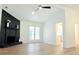 Bright living room with wood-look flooring, black stone fireplace, and French doors at 5974 Sw Four Winds Sw Dr, Lilburn, GA 30047