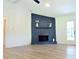 Bright living room with wood-look flooring and a stone fireplace at 5974 Sw Four Winds Sw Dr, Lilburn, GA 30047