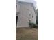 Side exterior view of a home with vinyl siding, showcasing windows and potential maintenance needs at 6265 Gemstone Ct, South Fulton, GA 30349