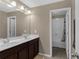 Bathroom boasts a double sink vanity and a separate shower/tub combo at 935 Grove Valley Drive Dr, Cumming, GA 30041