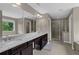 Bathroom featuring a large vanity with double sinks, granite countertops, and a glass enclosed shower at 935 Grove Valley Drive Dr, Cumming, GA 30041