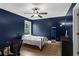 Bedroom features hardwood floors, a ceiling fan and a large window with views of the outdoors at 935 Grove Valley Drive Dr, Cumming, GA 30041